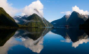 Milford Sound is a fjord carved out by a glacier, which created a narrow inlet, lined by steep cliffs and waterfalls.