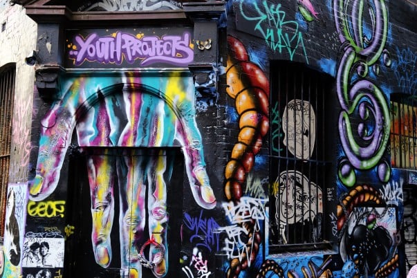 Door and windows are all covered with colorful graffiti giving them a unique feel